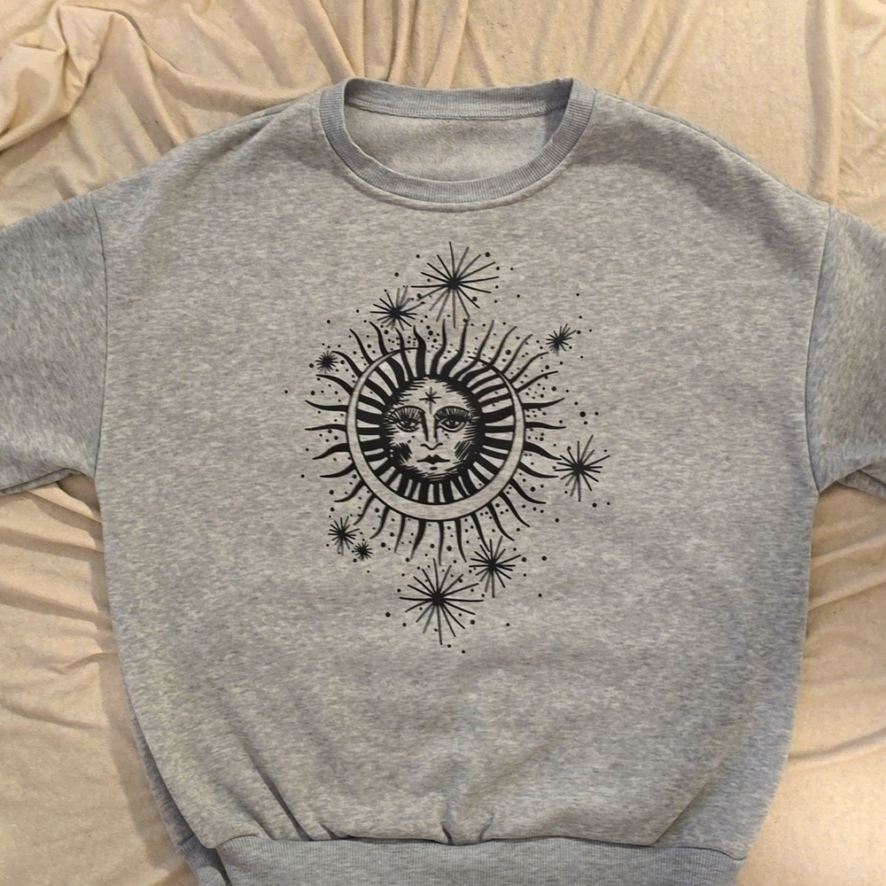 Gently worn heather gray sweatshirt with black sun/moon decal!